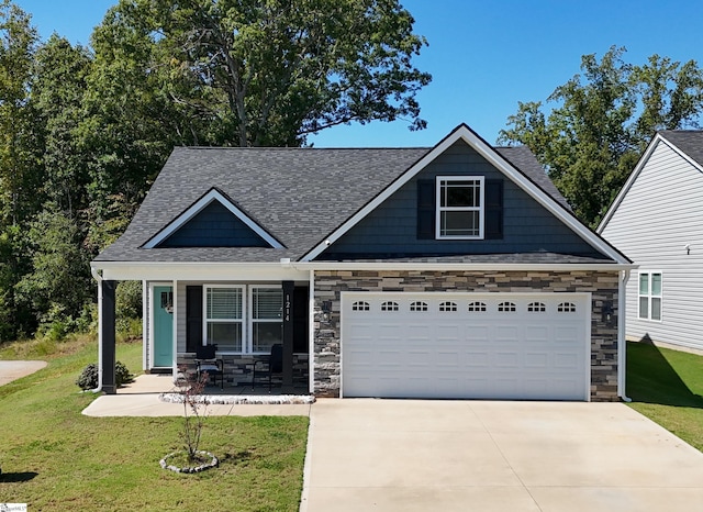 craftsman-style house featuring a porch, a front lawn, and a garage