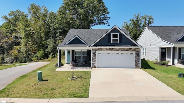 view of front facade with a front lawn, covered porch, and a garage