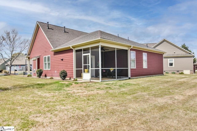 back of house featuring a sunroom and a lawn