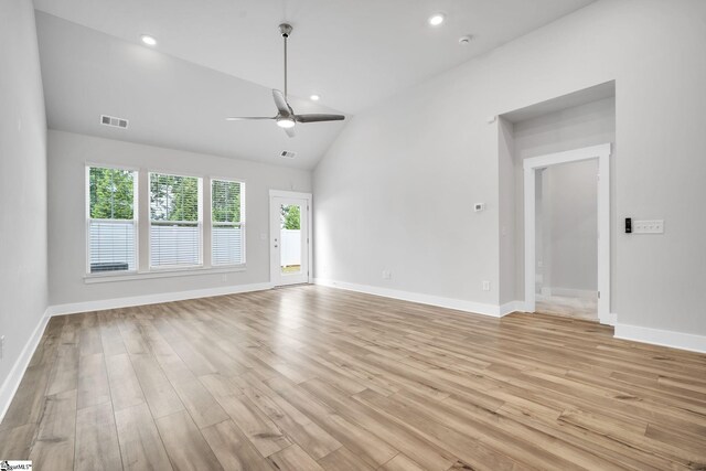 unfurnished living room with ceiling fan, high vaulted ceiling, and light wood-type flooring