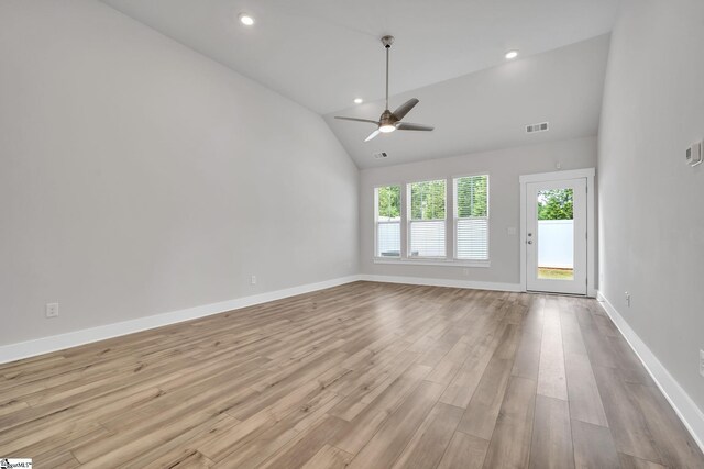 spare room with lofted ceiling, ceiling fan, and light wood-type flooring