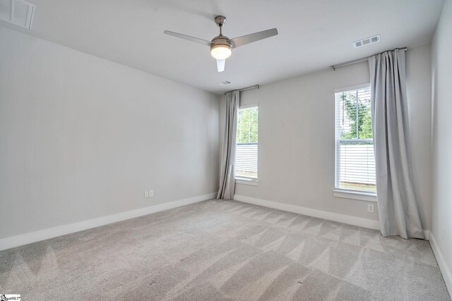 carpeted spare room with ceiling fan