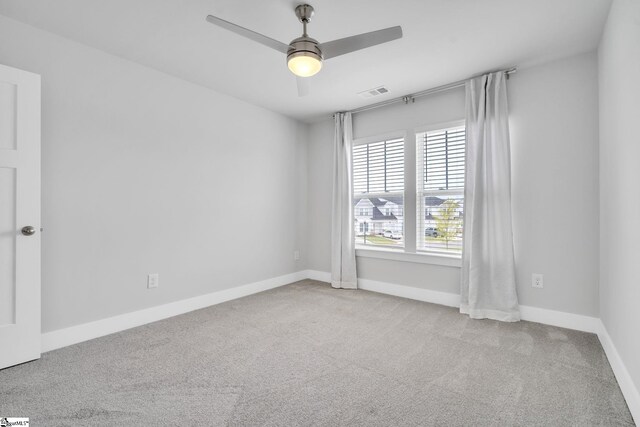 unfurnished room featuring light colored carpet and ceiling fan