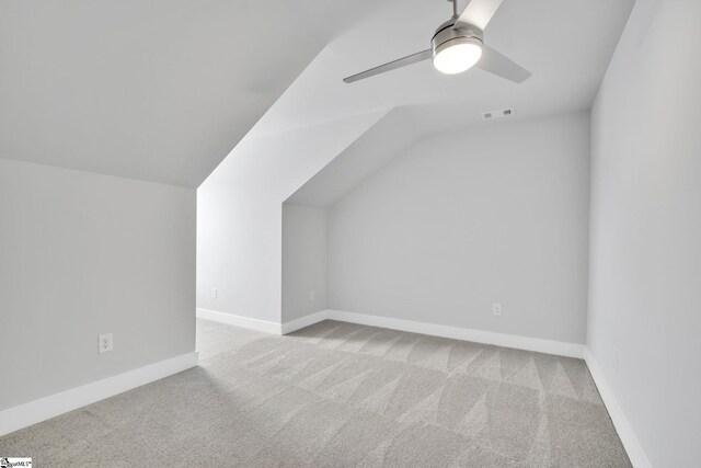 bonus room with ceiling fan, vaulted ceiling, and light carpet