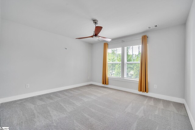 carpeted spare room featuring ceiling fan