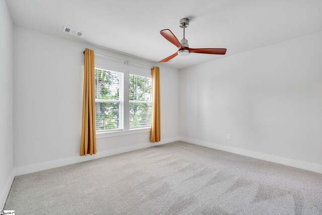 carpeted empty room featuring plenty of natural light and ceiling fan