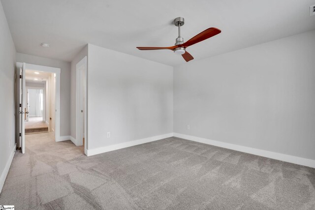 carpeted empty room with ceiling fan