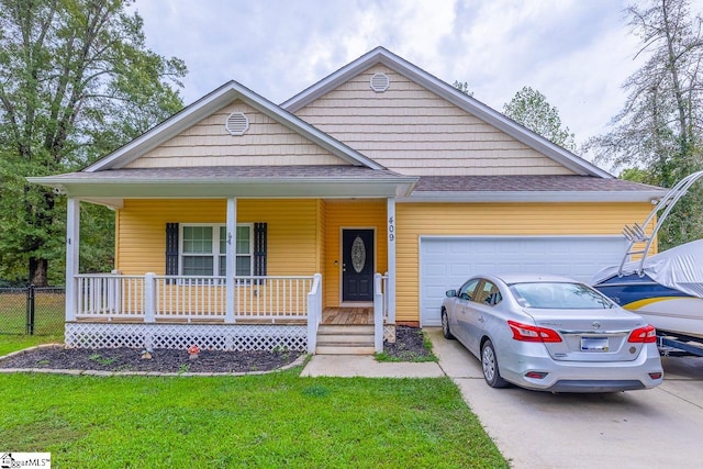 view of front facade with a front yard, a garage, and covered porch