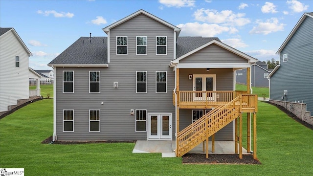 back of property with french doors, a yard, a wooden deck, and a patio area