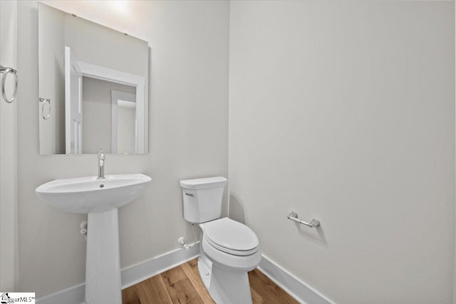 bathroom featuring toilet and hardwood / wood-style floors