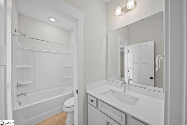 full bathroom featuring shower / tub combination, hardwood / wood-style floors, vanity, and toilet