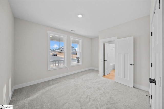 unfurnished bedroom featuring light colored carpet