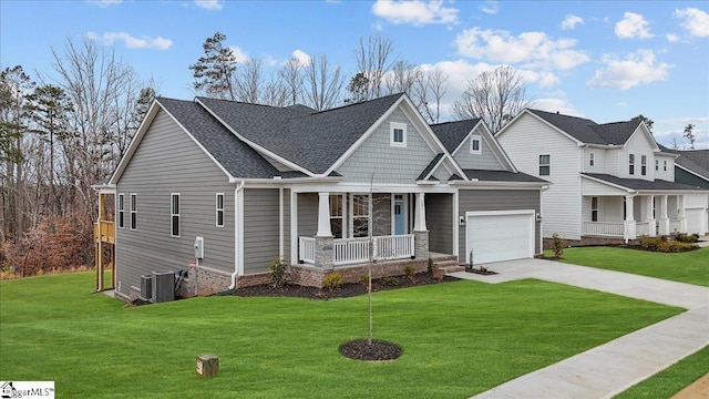 craftsman inspired home with cooling unit, a porch, a garage, and a front lawn