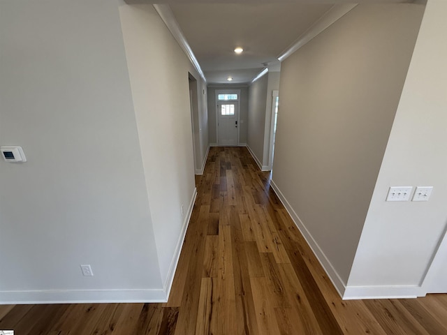 hallway featuring hardwood / wood-style flooring and crown molding