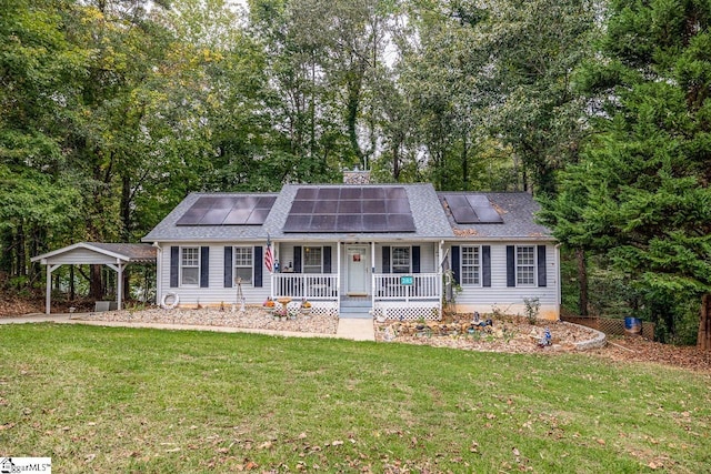 view of front of house featuring a carport, a front lawn, solar panels, and covered porch