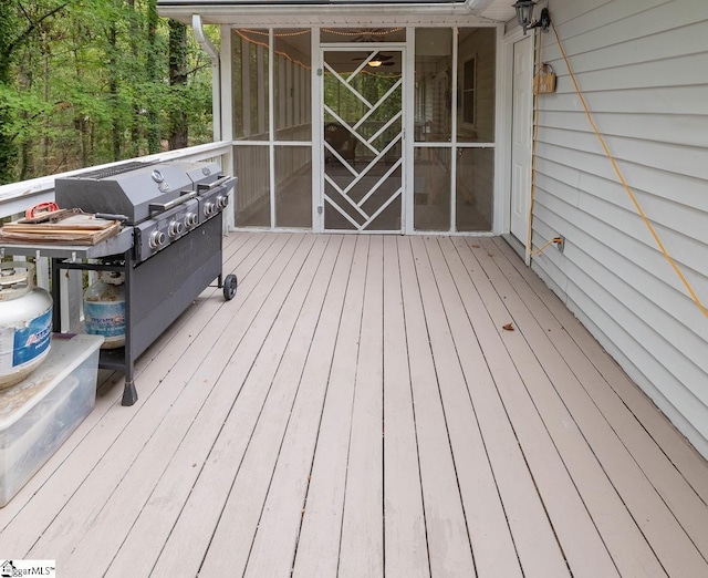 wooden terrace featuring a grill