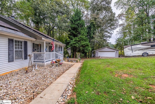 view of yard with an outdoor structure, a garage, and a porch