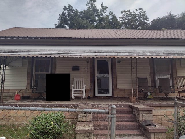 rear view of property featuring a porch