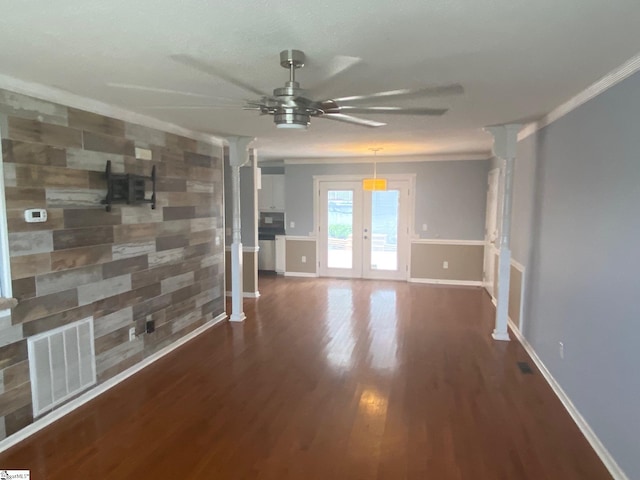 empty room with ceiling fan, dark hardwood / wood-style floors, french doors, and crown molding