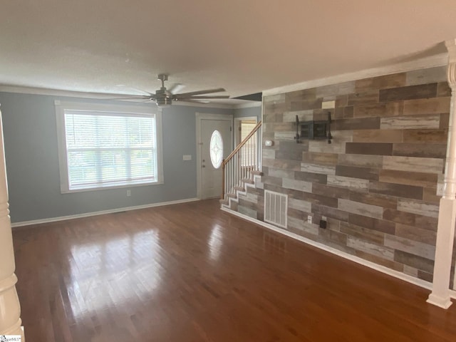 unfurnished living room with ceiling fan and dark hardwood / wood-style flooring