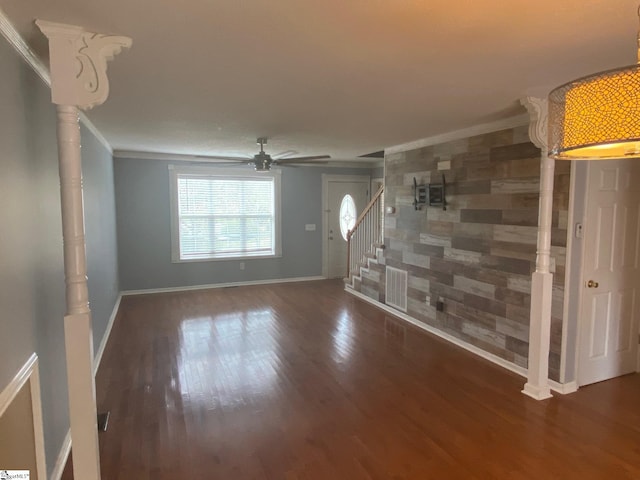 spare room featuring crown molding, dark hardwood / wood-style floors, and ceiling fan