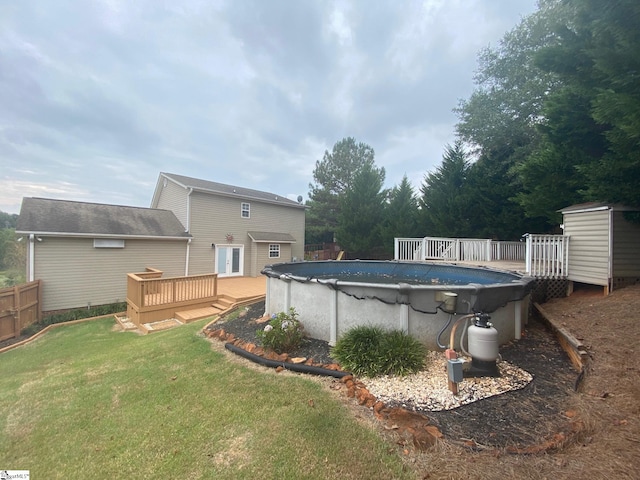 view of pool with a deck and a yard