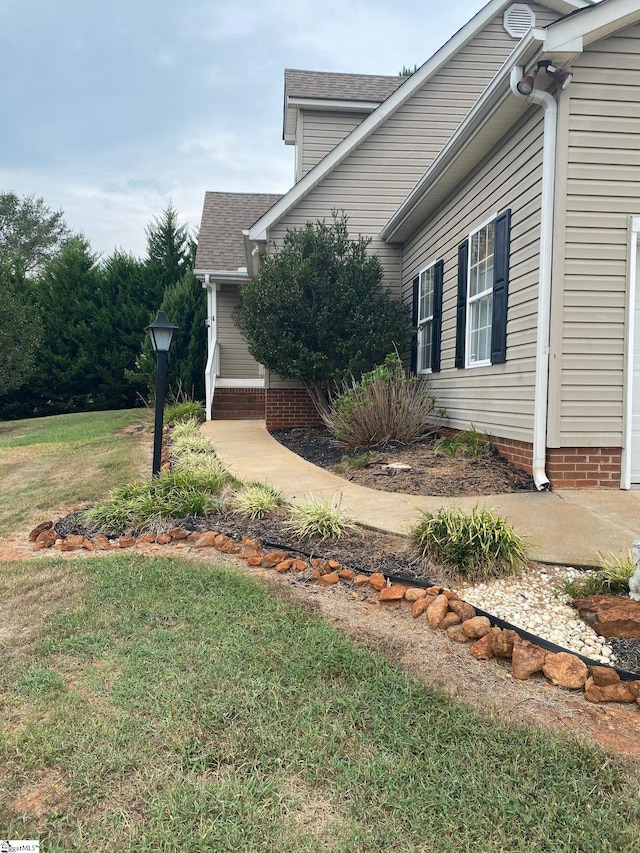 view of property exterior with a yard