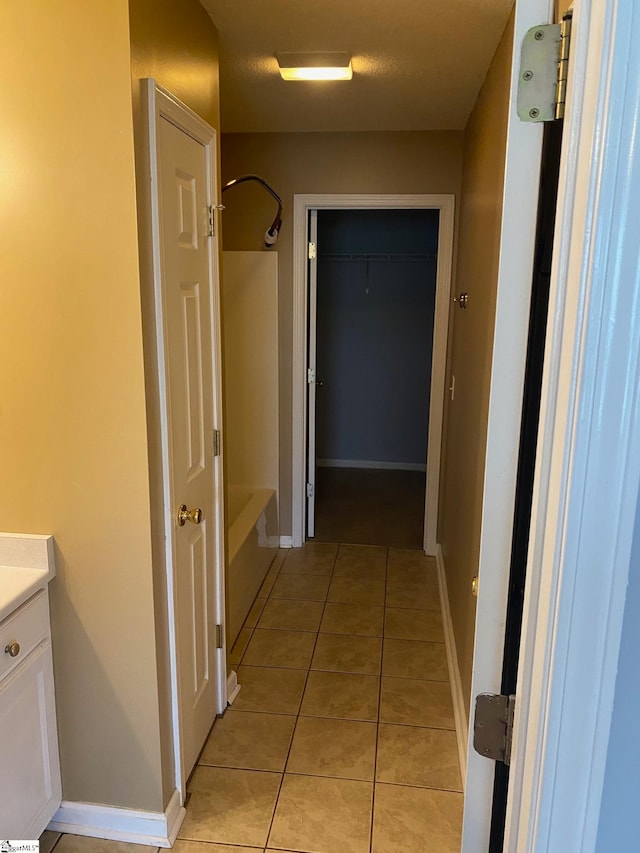 hallway featuring light tile patterned floors