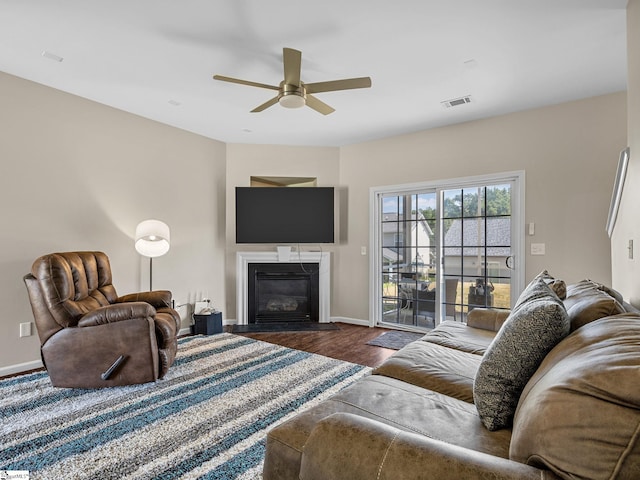 living room featuring dark hardwood / wood-style flooring and ceiling fan