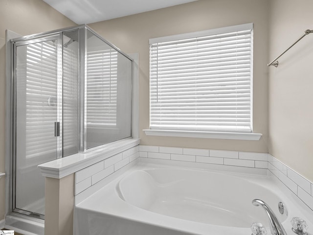 bathroom featuring separate shower and tub and a wealth of natural light