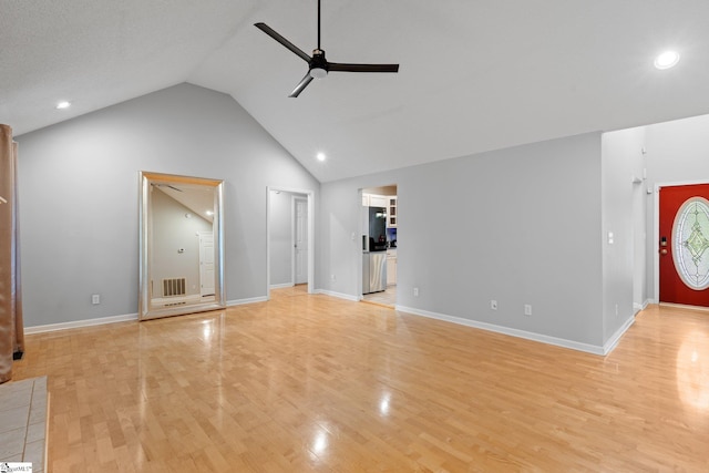 unfurnished living room with ceiling fan, lofted ceiling, and light hardwood / wood-style floors