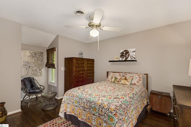 bedroom with ceiling fan and dark wood-type flooring