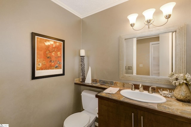 bathroom featuring a textured ceiling, crown molding, vanity, and toilet