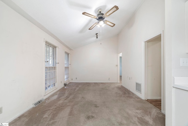 carpeted empty room with high vaulted ceiling and ceiling fan