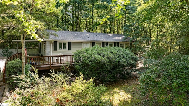 rear view of house with a wooden deck