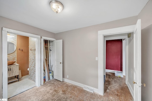 unfurnished bedroom with a closet and ensuite bathroom