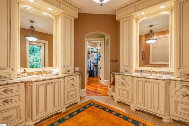 bathroom with vanity, vaulted ceiling, and hardwood / wood-style flooring