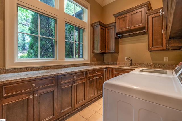 laundry room featuring cabinets, independent washer and dryer, light tile patterned floors, and sink