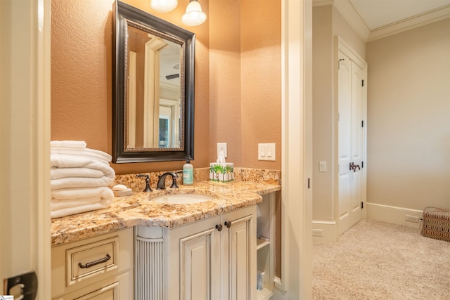 bathroom with ornamental molding and vanity