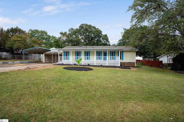 view of front of house with a front lawn, a carport, and a porch