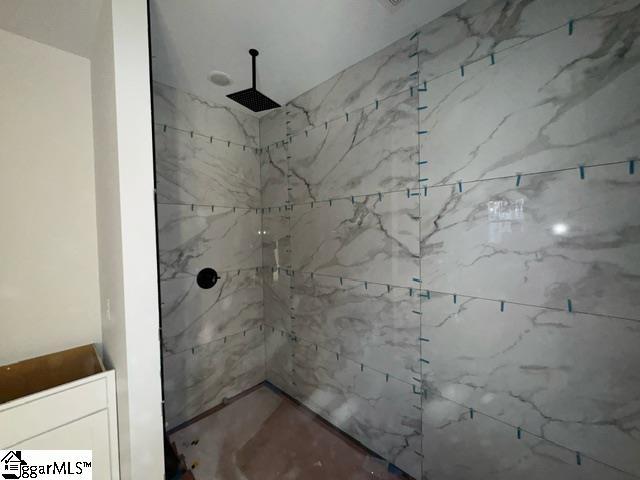 bathroom with tiled shower