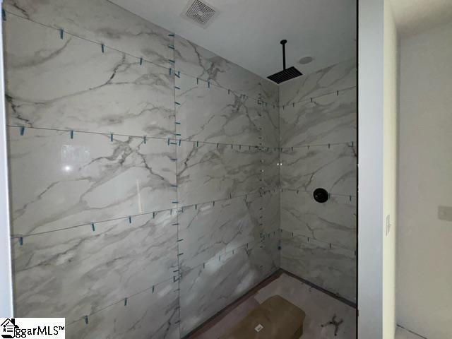 bathroom with tiled shower