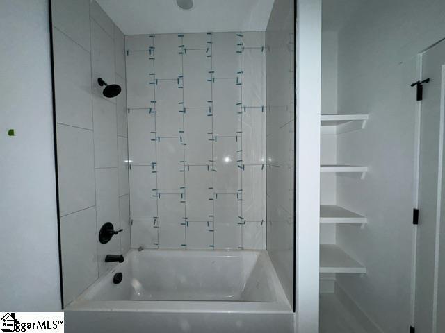 bathroom with bathing tub / shower combination