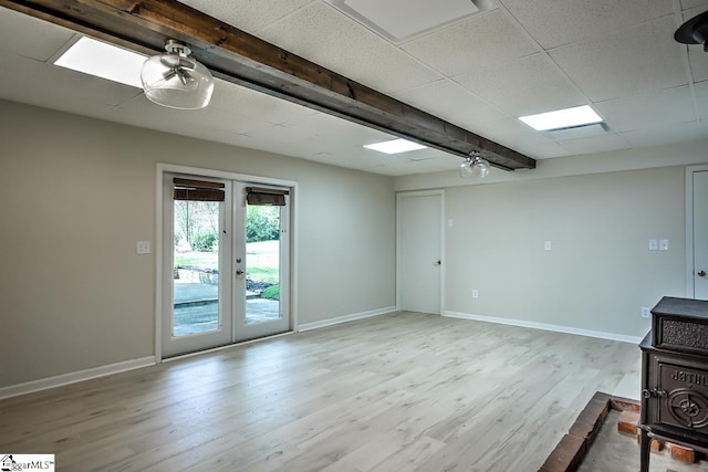 unfurnished room featuring light hardwood / wood-style floors, ceiling fan, and french doors