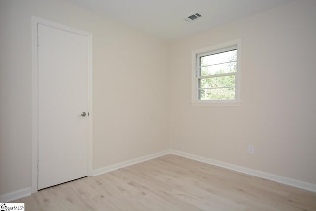 spare room featuring light hardwood / wood-style floors