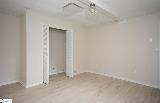 unfurnished bedroom with light hardwood / wood-style flooring and a closet