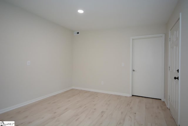 spare room featuring light hardwood / wood-style flooring