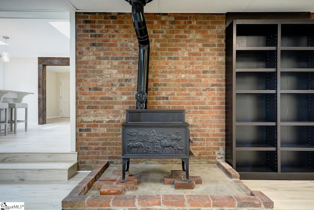 details featuring wood-type flooring and a wood stove