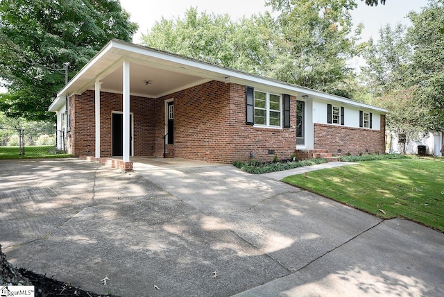 ranch-style home with a front yard and a carport