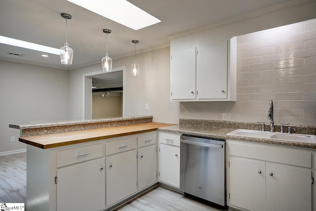 kitchen with pendant lighting, white cabinets, kitchen peninsula, light hardwood / wood-style flooring, and dishwasher